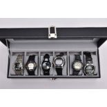 A WATCH DISPLAY CASE WITH DIGITAL WRISTWATCHES, black and glass panelled display case with six