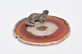 A WHITE METAL OTTER ON AN AGATE AND SILVER MOUNTED BASE, textured figure of an otter fixed onto a