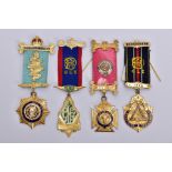FOUR SILVER GILT, MASONIC MEDALS, of various designs decorated with blue, red, green and white