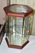 A MODERN HEXAGONAL TABLE TOP DISPLAY CASE, the wooden top with circular glazed panel above six