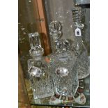 FOUR CUT GLASS DECANTERS, comprising a Waterford ships decanter and stopper and a Waterford mallet