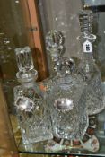 FOUR CUT GLASS DECANTERS, comprising a Waterford ships decanter and stopper and a Waterford mallet