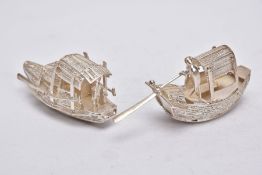 TWO MODERN ORIENTAL, WHITE METAL FILIGREE BOAT ORNAMENTS, one with a standing figure with paddle,