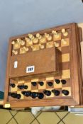 A MID 20TH CENTURY WOODEN CHESS BOARD AND CHESS PIECES, the board with lift off top opening to