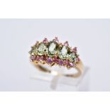 A 9CT GOLD GEM SET HALF HOOP RING, designed with five oval cut graduated green stones assessed as