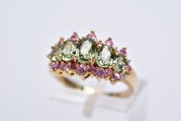 A 9CT GOLD GEM SET HALF HOOP RING, designed with five oval cut graduated green stones assessed as