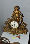 A LATE 19TH CENTURY FRENCH GILT METAL FIGURAL MANTEL CLOCK, the case cast with a putti holding an