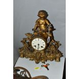 A LATE 19TH CENTURY FRENCH GILT METAL FIGURAL MANTEL CLOCK, the case cast with a putti holding an