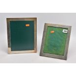 TWO SILVER PHOTO FRAMES, each of a rectangular form, the largest measuring approximately 26cm x