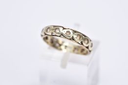 A 9CT GOLD FULL ETERNITY RING, set with colourless stones assessed as spinel, each within a heart