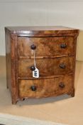 A VICTORIAN BURR WALNUT VENEERED MINIATURE BOW FRONT CHEST OF THREE DRAWERS, turned wooden