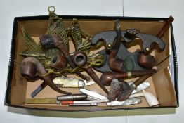 A SMALL BOX OF SUNDRIES, to include various pipes (one with sterling silver collar) and stands,