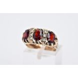 A LATE 20TH CENTURY 9CT GOLD GARNET RING, designed with three oval cut garnets, interspaced with