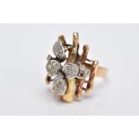 A YELLOW METAL DIAMOND SET RING, of a floral and bark textured design in the style of Andrew