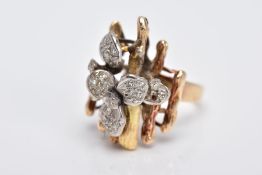 A YELLOW METAL DIAMOND SET RING, of a floral and bark textured design in the style of Andrew