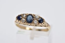 A 9CT GOLD SAPPPHIRE AND PASTE RING, centring on an oval cut blue sapphire flanked with colourless