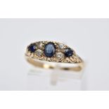 A 9CT GOLD SAPPPHIRE AND PASTE RING, centring on an oval cut blue sapphire flanked with colourless