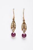 A PAIR OF EDWARDAN, GARNET AND SPLIT PEARL DROP EARRINGS, each yellow metal earring, set with a