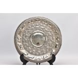 AN INDIAN WHITE METAL PRESENTATION SALVER, embossed animal and foliate design, engraved to the