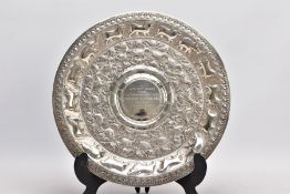 AN INDIAN WHITE METAL PRESENTATION SALVER, embossed animal and foliate design, engraved to the