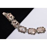 A WHITE METAL AND ROSE GOLD TONE BRACELET, designed with five openwork links, set with rose gold