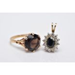 A 9CT GOLD SMOKEY QUARTZ RING AND A 9CT GOLD SAPPHIRE PENDANT, the ring designed with a claw set,