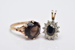 A 9CT GOLD SMOKEY QUARTZ RING AND A 9CT GOLD SAPPHIRE PENDANT, the ring designed with a claw set,