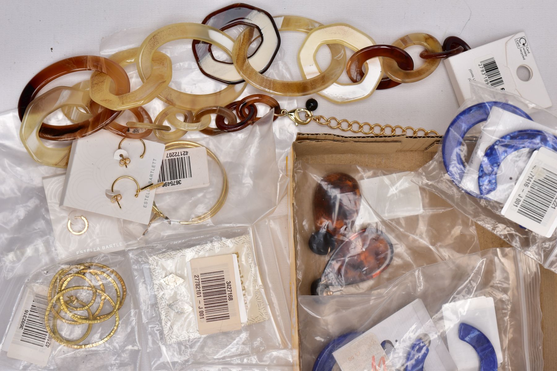 A TRAY OF COSTUME JEWELLERY, some pieces with tags and packaging, to include a large resin hoop - Image 2 of 4