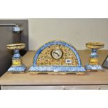 A CONTINENTAL CLOCK GARNITURE, the dome shaped porcelain clock is branded M.W inside a triangle,