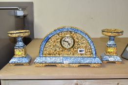 A CONTINENTAL CLOCK GARNITURE, the dome shaped porcelain clock is branded M.W inside a triangle,