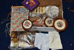 A BOX OF WOOLWORK, including three framed completed floral woolworks, a woolwork instruction