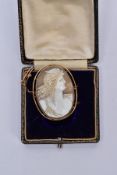 A GOLD CAMEO BROOCH, depicting a maiden in profile, measuring approximately 42mm x 33mm, stamped '