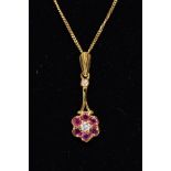 A LATE 20TH CENTRY 18CT GOLD RUBY AND DIAMOND ROUND CLUSTER DROP PENDANT AND CHAIN, pendant