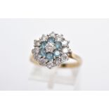 A 9CT GOLD DRESS RING, tiered cluster set with circular cut colourless stones assessed as paste,