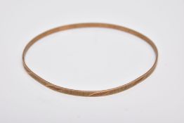 A 9CT GOLD BANGLE, thin bangle with a textured and foliate engraved design, hallmarked 9ct gold