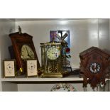 SIX CLOCKS COMPRISING A GERMAN ANNUAL ANNIVERSARY CLOCK, two Rapport of London carriage clocks,