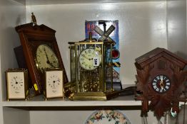 SIX CLOCKS COMPRISING A GERMAN ANNUAL ANNIVERSARY CLOCK, two Rapport of London carriage clocks,