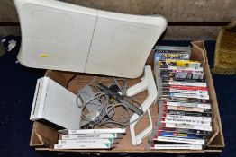 A BOX OF GAMING ITEMS, to include Wii console and Wii fit board and game, various other games (