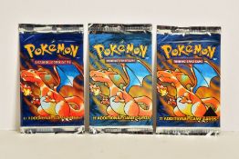 A SEALED POKEMON BASE SET BLACK TRIANGLE ERROR PRINTED BOOSTER PACK, with two other sealed Base