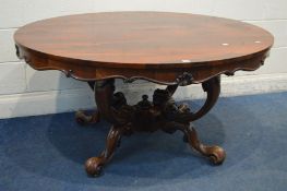 AN EARLY VICTORIAN ROSEWOOD OVAL TOP BREAKFAST TABLE, with a wavy apron, four scrolled supports