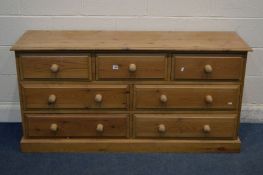 A PINE SIDEBOARD/CHEST OF THREE SHORT AND FOUR LONG DRAWERS, width 152cm x depth 46cm x height 76cm