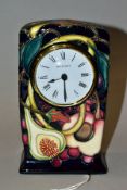 A MOORCROFT POTTERY TIMEPIECE, Queens Choice pattern designed by Emma Bossons, impressed and painted