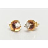 A PAIR OF YELLOW METAL DIAMOND STUD EARRINGS, each designed with a claw set round brilliant cut