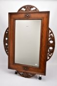 AN EARLY 20TH CENTURY ENGLISH OAK FRAMED MIRROR, circa 1920, with original bevelled edge plate,