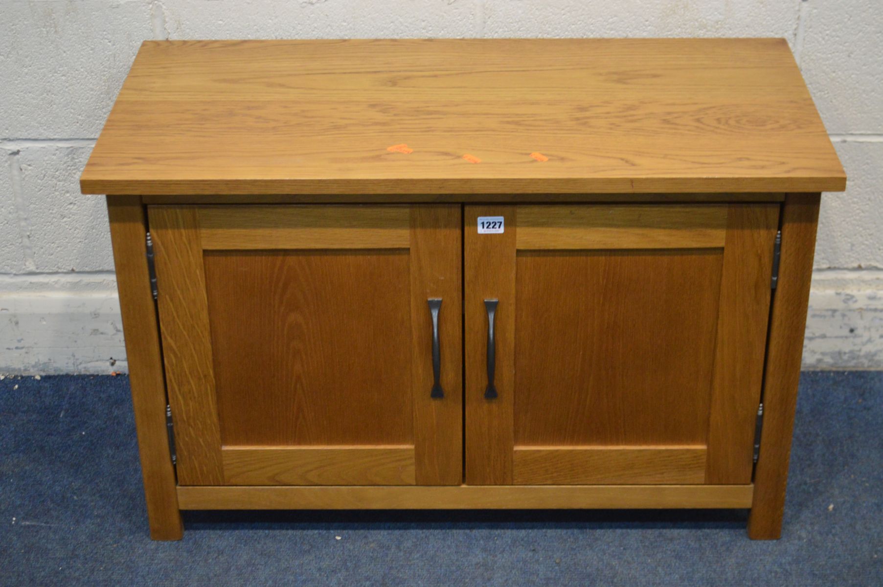 A LIGHT OAK TWO DOOR TV CABINET with one adjustable shelf width 89cm x depth 43cm x height 56cm