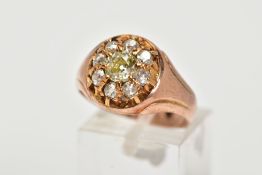 A LATE VICTORIAN 9CT ROSE GOLD DIAMOND CLUSTER RING, centring on a claw set, old cut diamond, within