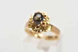 A YELLOW METAL SAPPHIRE CABOCHON RING, designed with a raised claw set sapphire cabochon, upon an