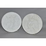 A PAIR OF ROYAL COPENHAGEN CIRCULAR PARIAN PLAQUES, both moulded in relief with angels with putti,