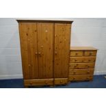 A PINE THREE DOOR WARDROBE, width 135cm x depth 60cm x height 183cm and a chest of two over four