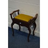 AN EDWARDIAN MAHOGANY PIANO STOOL, with mustard upholstery, shaped arm rests on cabriole legs,